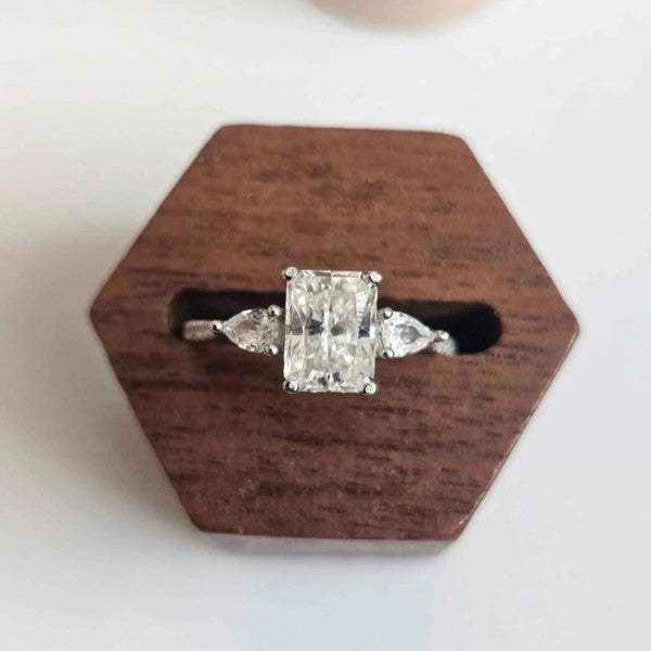Diamond ring on a wooden hexagonal stand with a white background