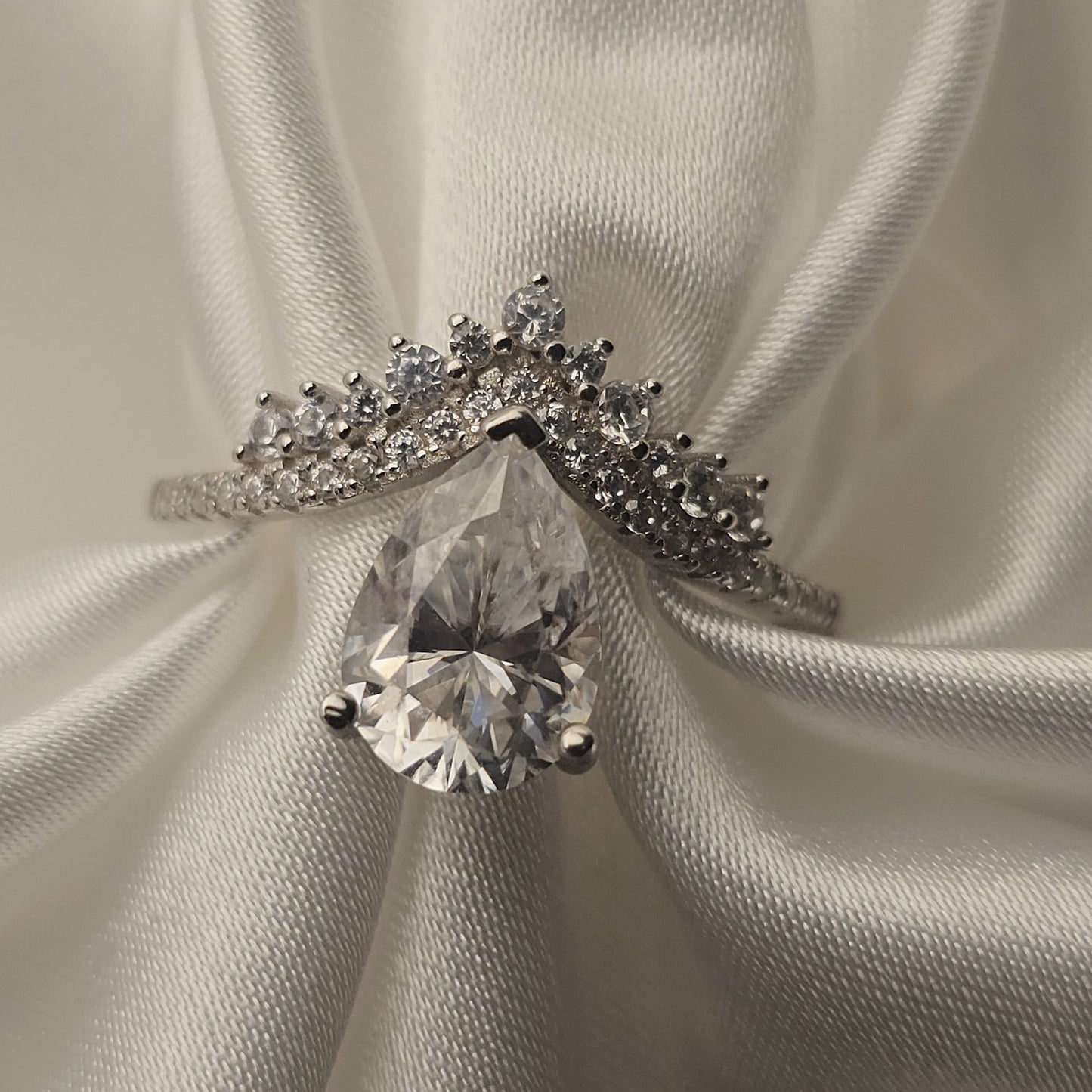 Diamond ring on a white satin background