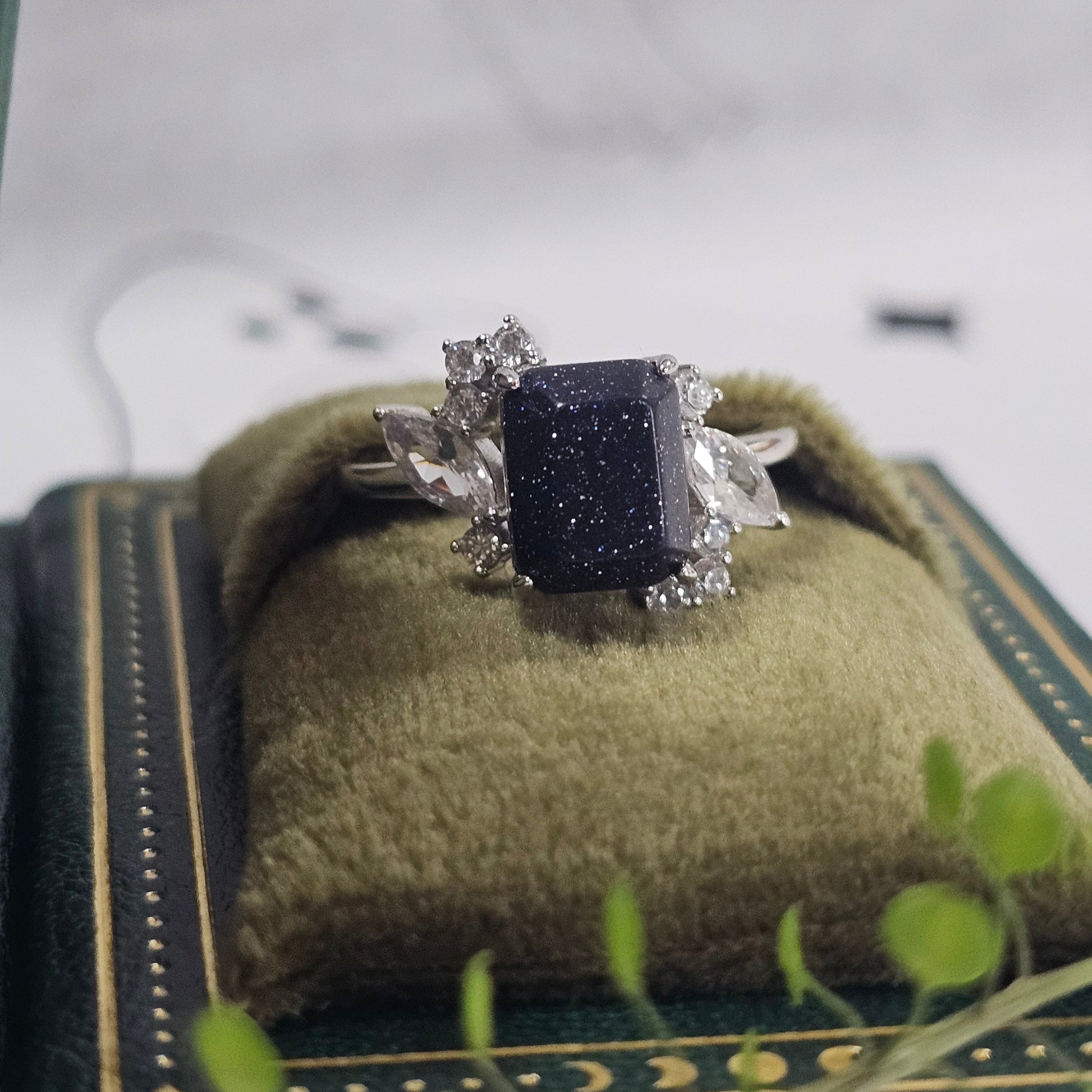 Silver earring with a black stone on a white surface
