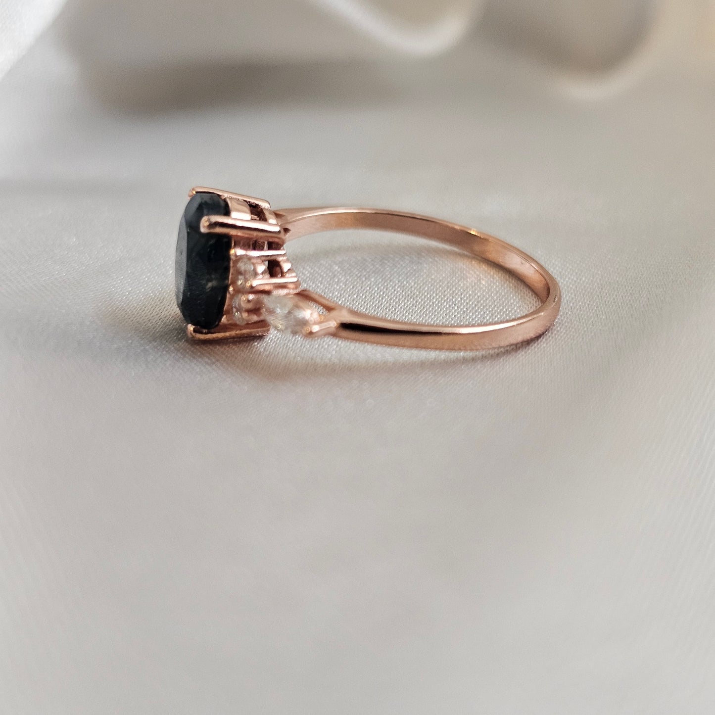 Rose gold ring with a moss agate gemstone on a light background