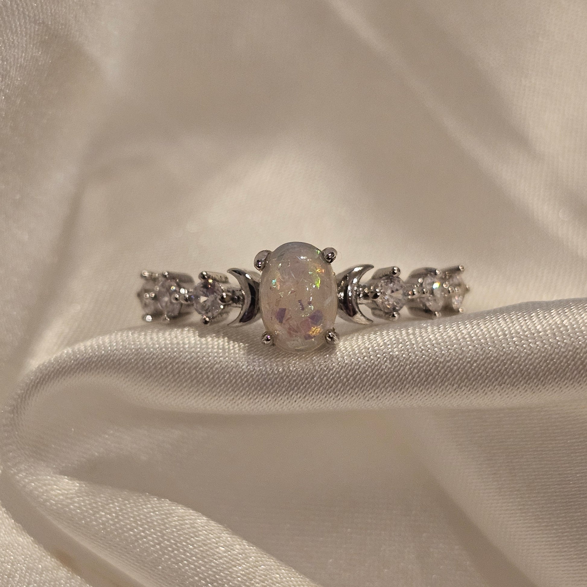 White opal ring on silk background