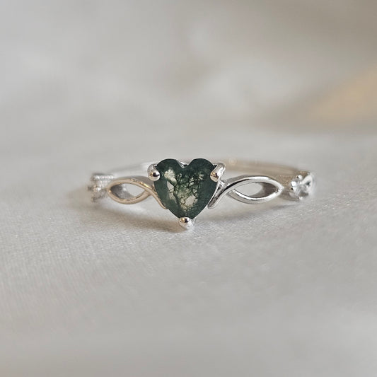 Close-up of Evergreen Heart Ring showing natural Moss Agate gemstone and infinity band design in polished sterling silver.