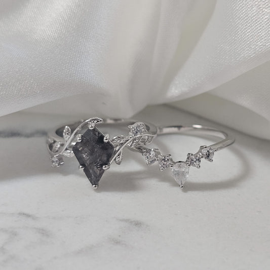 salt and pepper Herkimer diamond quartz ring set 925 silver with cubic zirconia accent stones sat on marble surface
