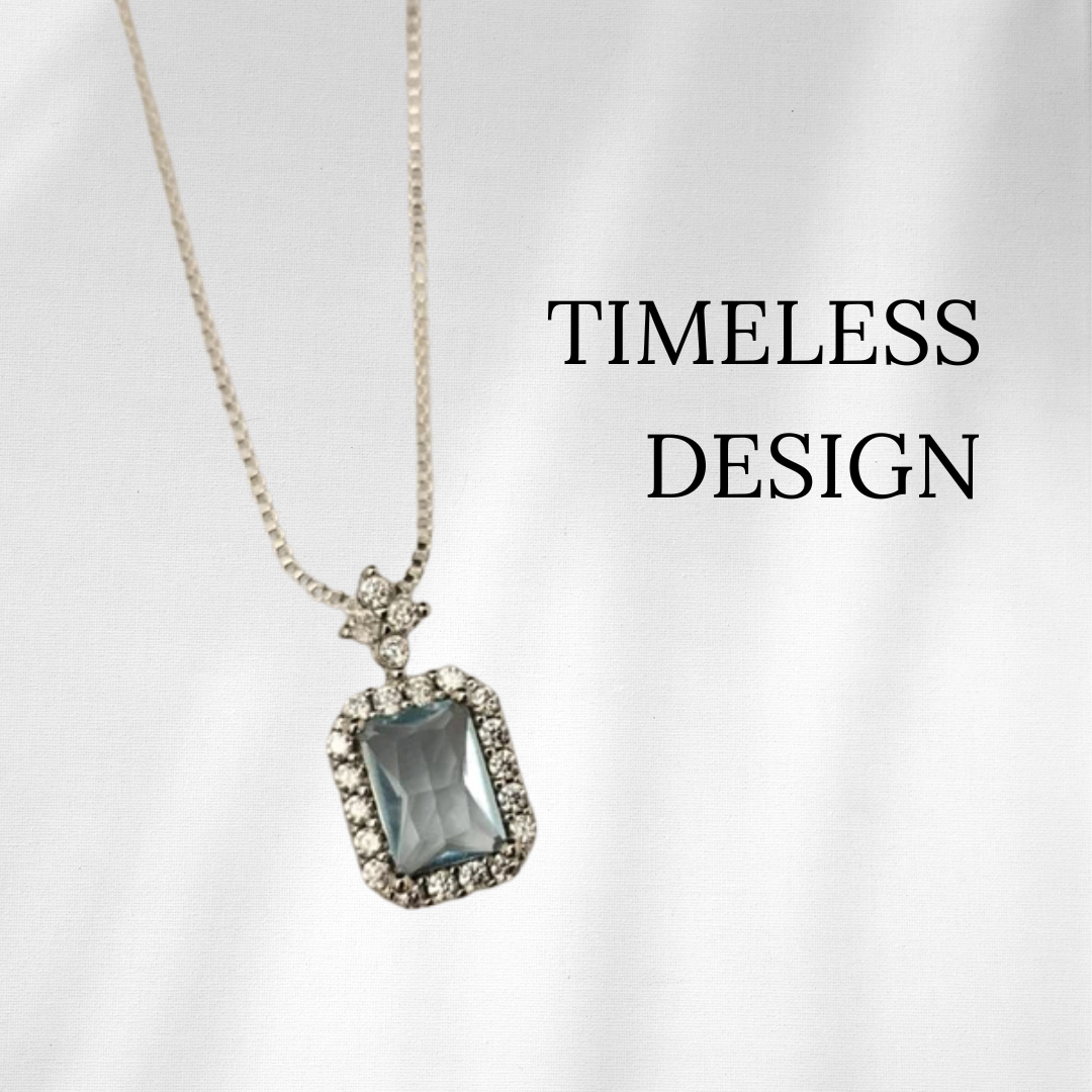 Necklace with a blue gemstone pendant on a white background, featuring the text 'Timeless Design'.