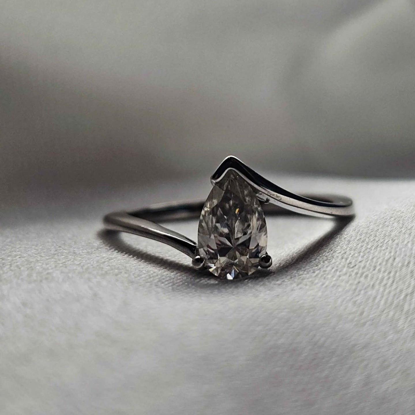 Diamond ring on a soft fabric background