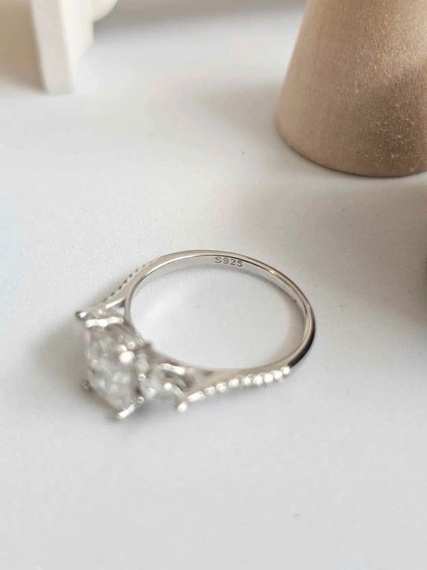 Silver ring with a large diamond on a light background