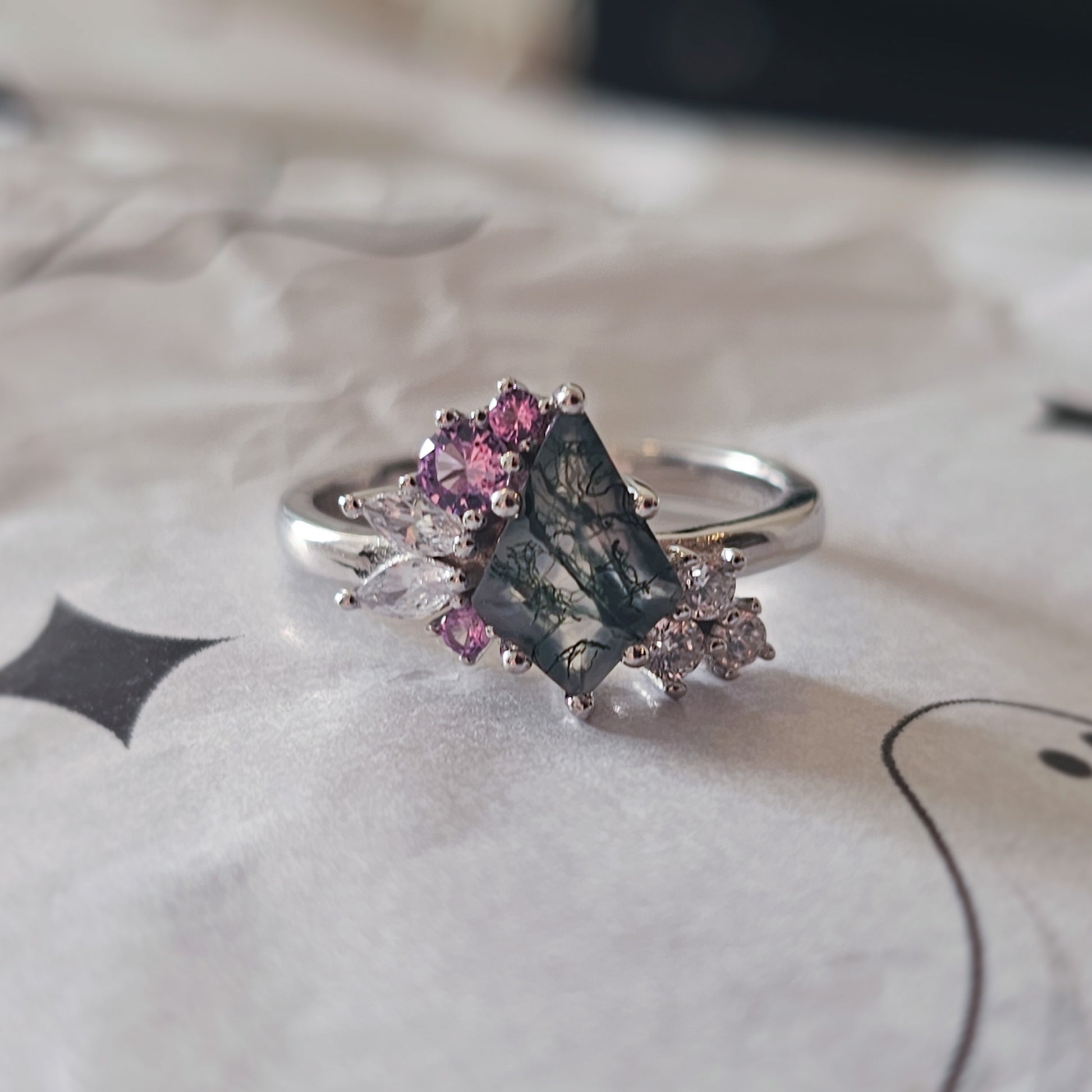 Moss Agate and Alexandrite ring in 925 sterling silver, featuring a kite-cut moss agate centre stone with natural green inclusions, accented by sparkling alexandrite and cubic zirconia stones on a polished silver band.