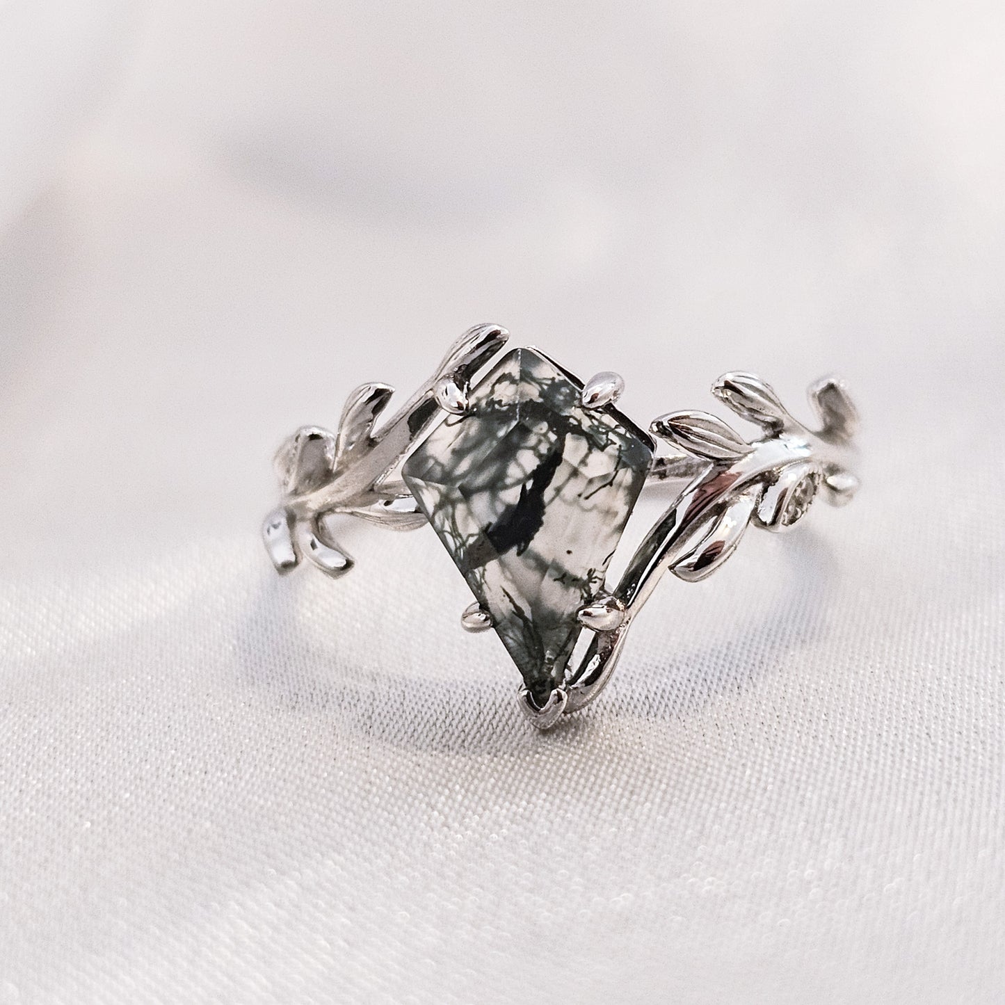 silver moss agate ring with leaf detail on silk background