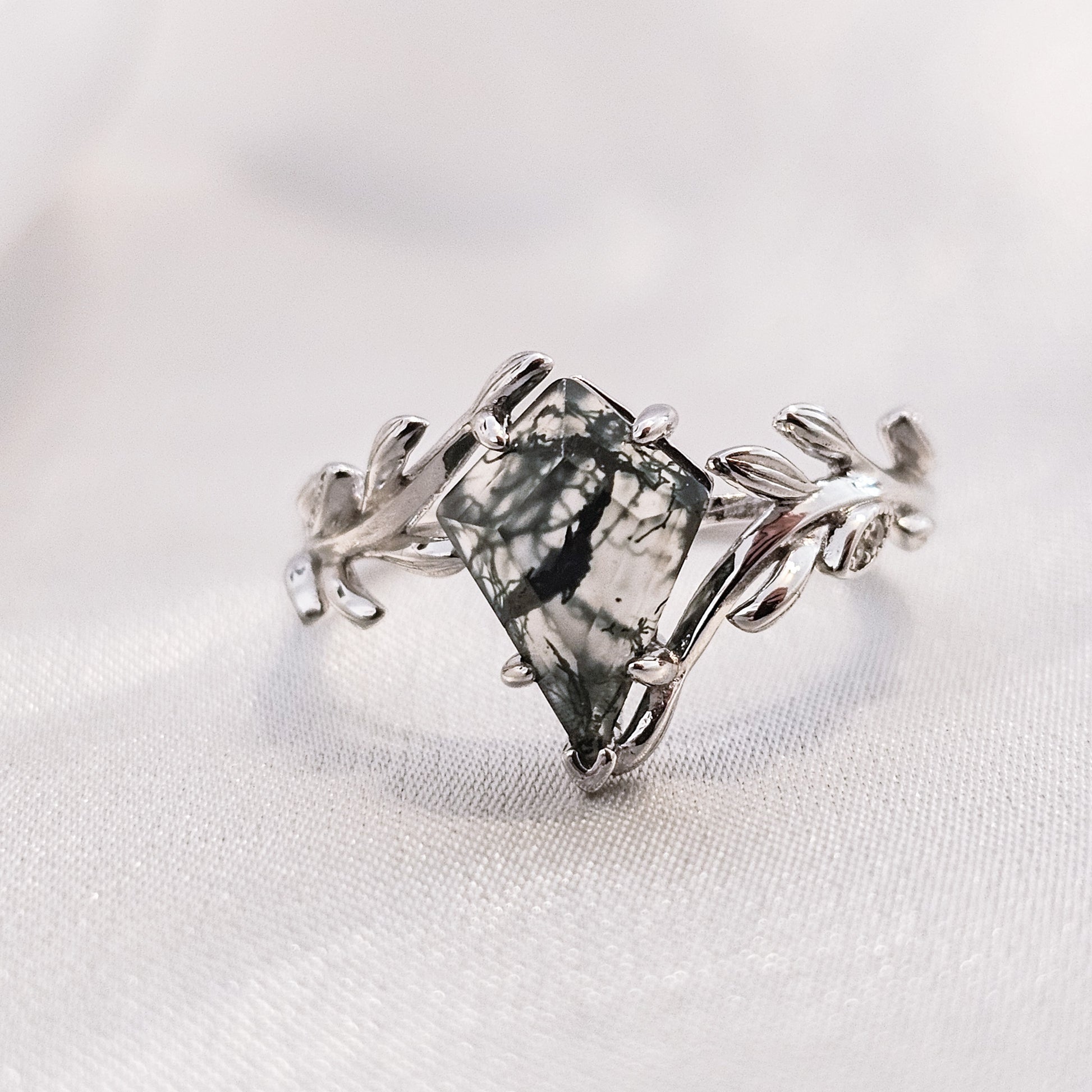 silver moss agate ring with leaf detail on silk background