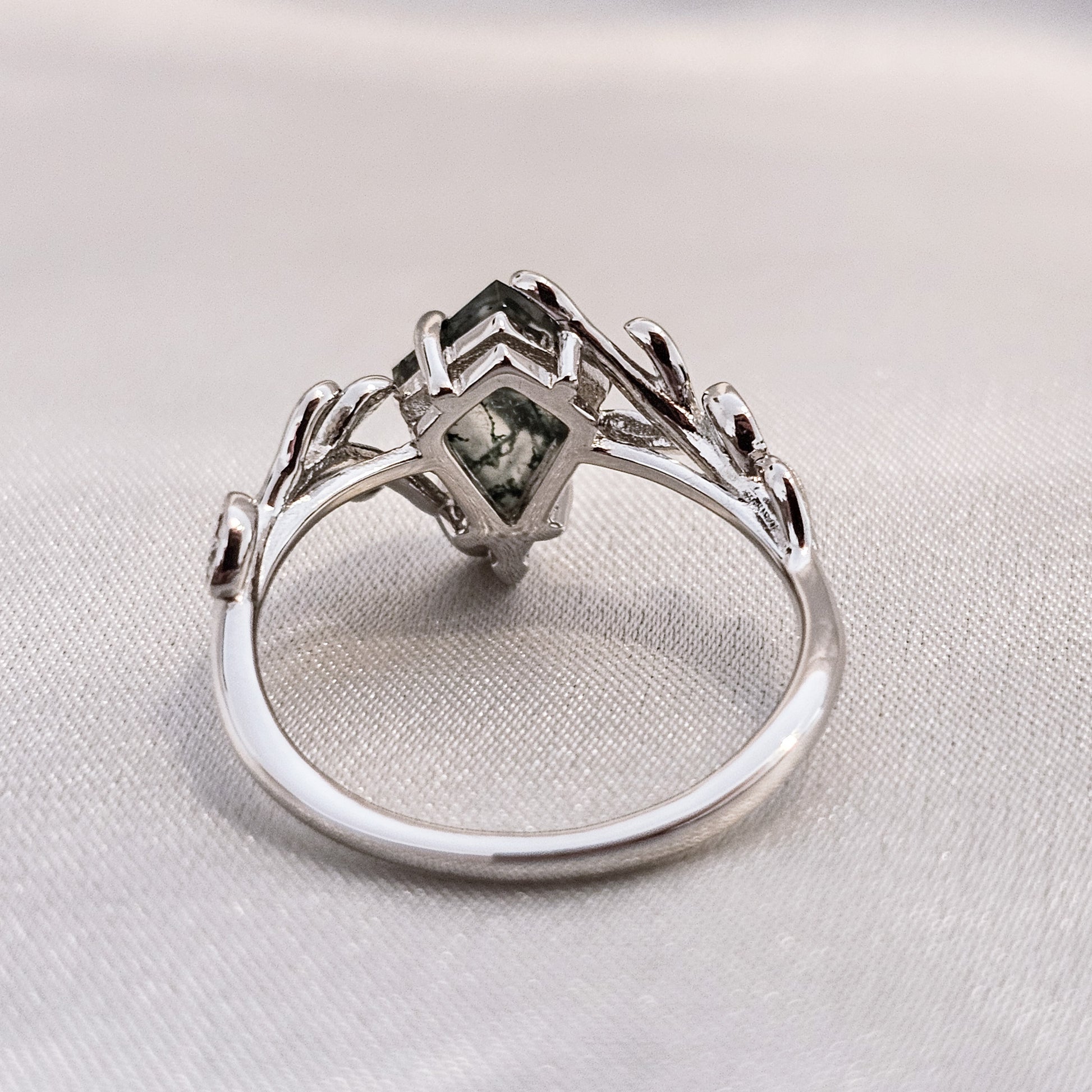 moss agate kite cut ring on silk background