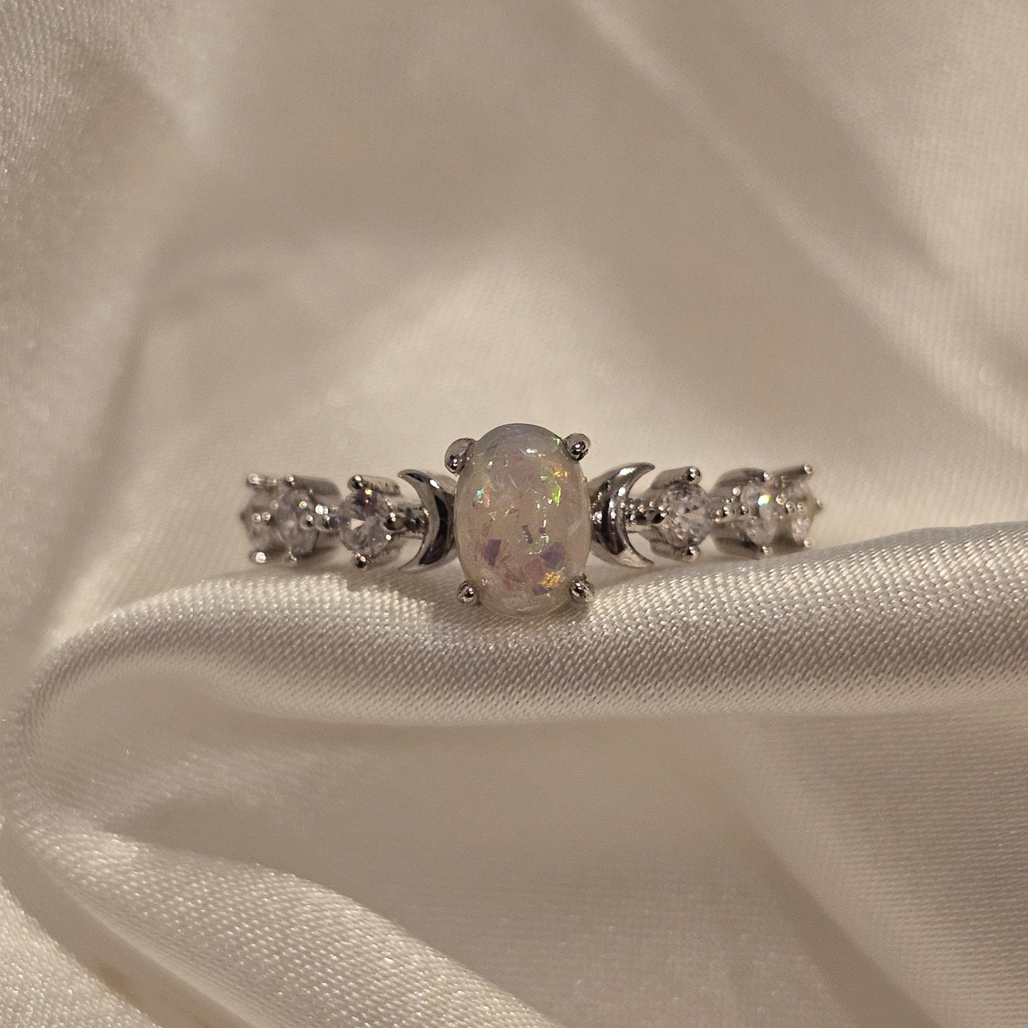 White opal ring on silk background