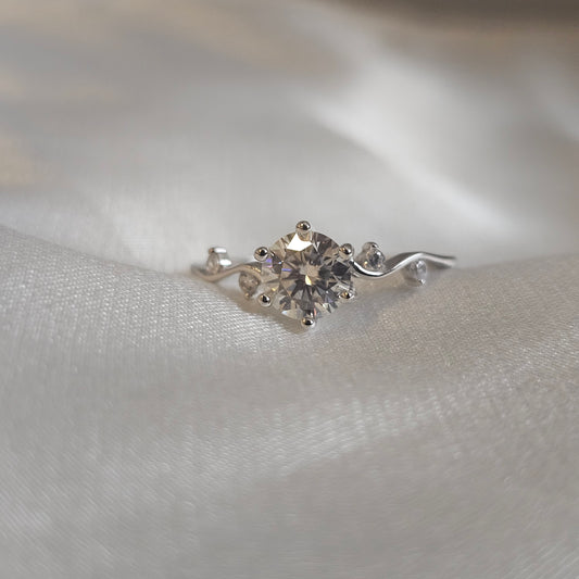 diamond moissanite ring on white silk background