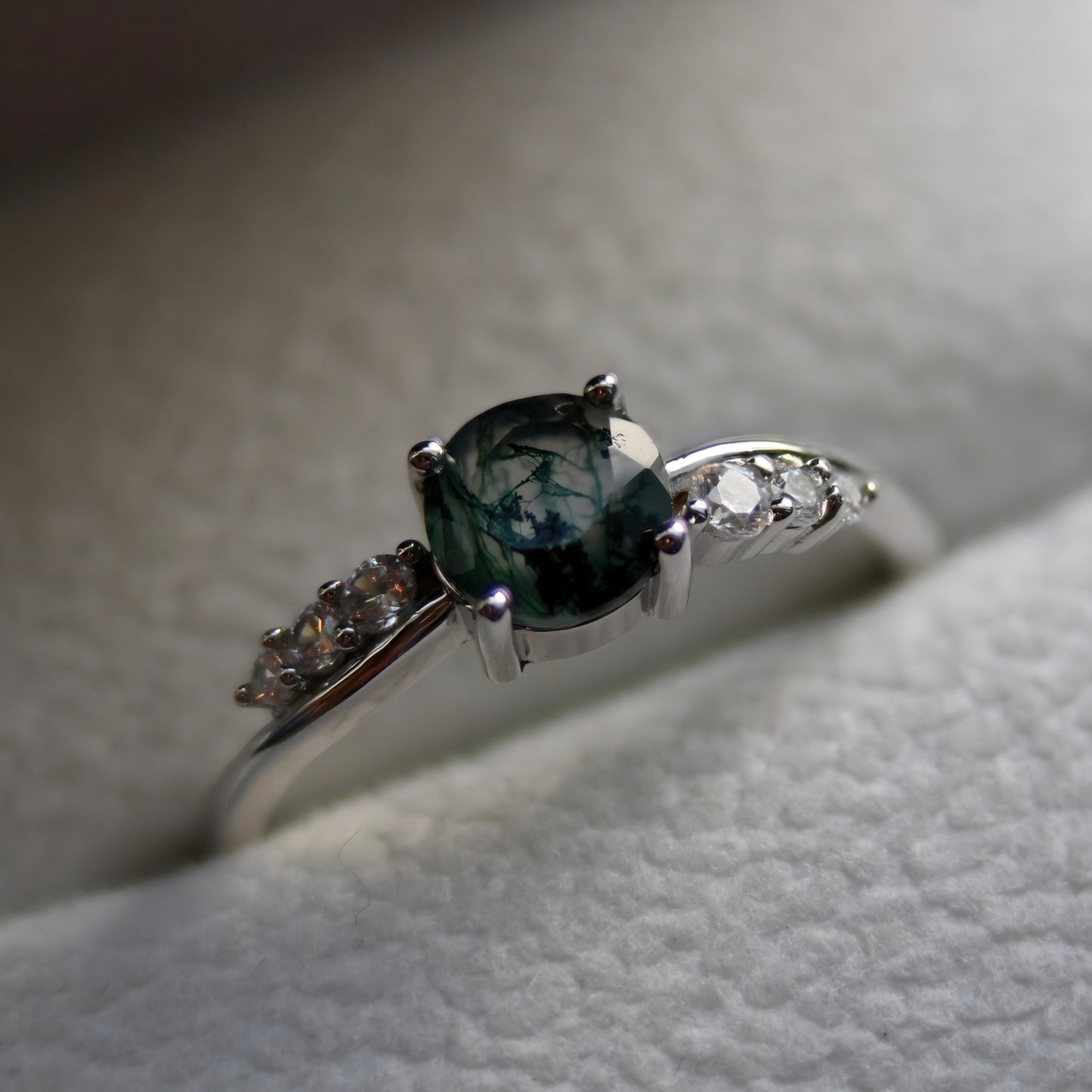Natural moss agate ring featuring an oval green moss agate gemstone with sparkling cubic zirconia accents, set in 925 sterling silver. Inspired by nature and known as the Gardener's Stone.