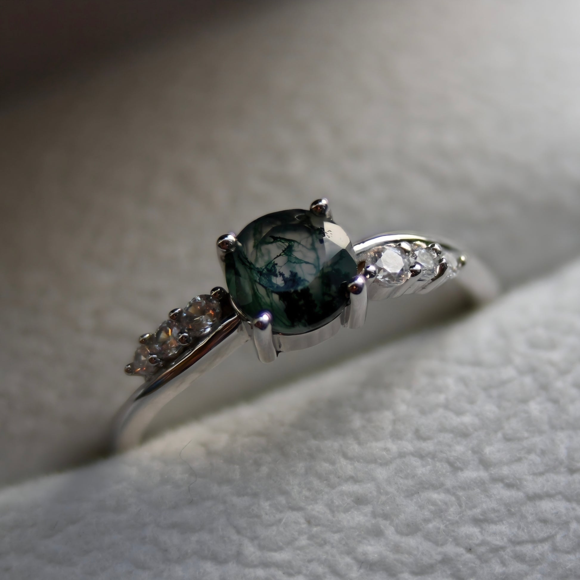 Natural moss agate ring featuring an oval green moss agate gemstone with sparkling cubic zirconia accents, set in 925 sterling silver. Inspired by nature and known as the Gardener's Stone.