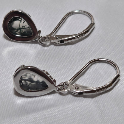 Silver teardrop earrings on a white background