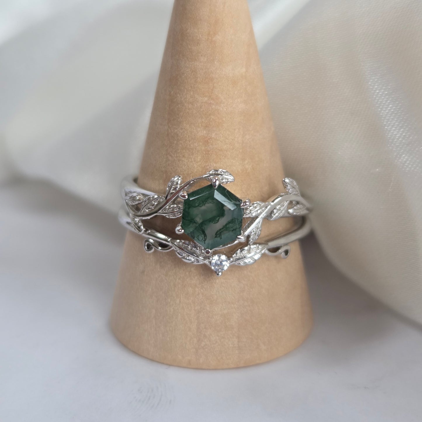 Moss agate bridal set on ring stand – natural green moss agate engagement ring and sterling silver band with cubic zirconia accents, nature‑inspired wedding ring set