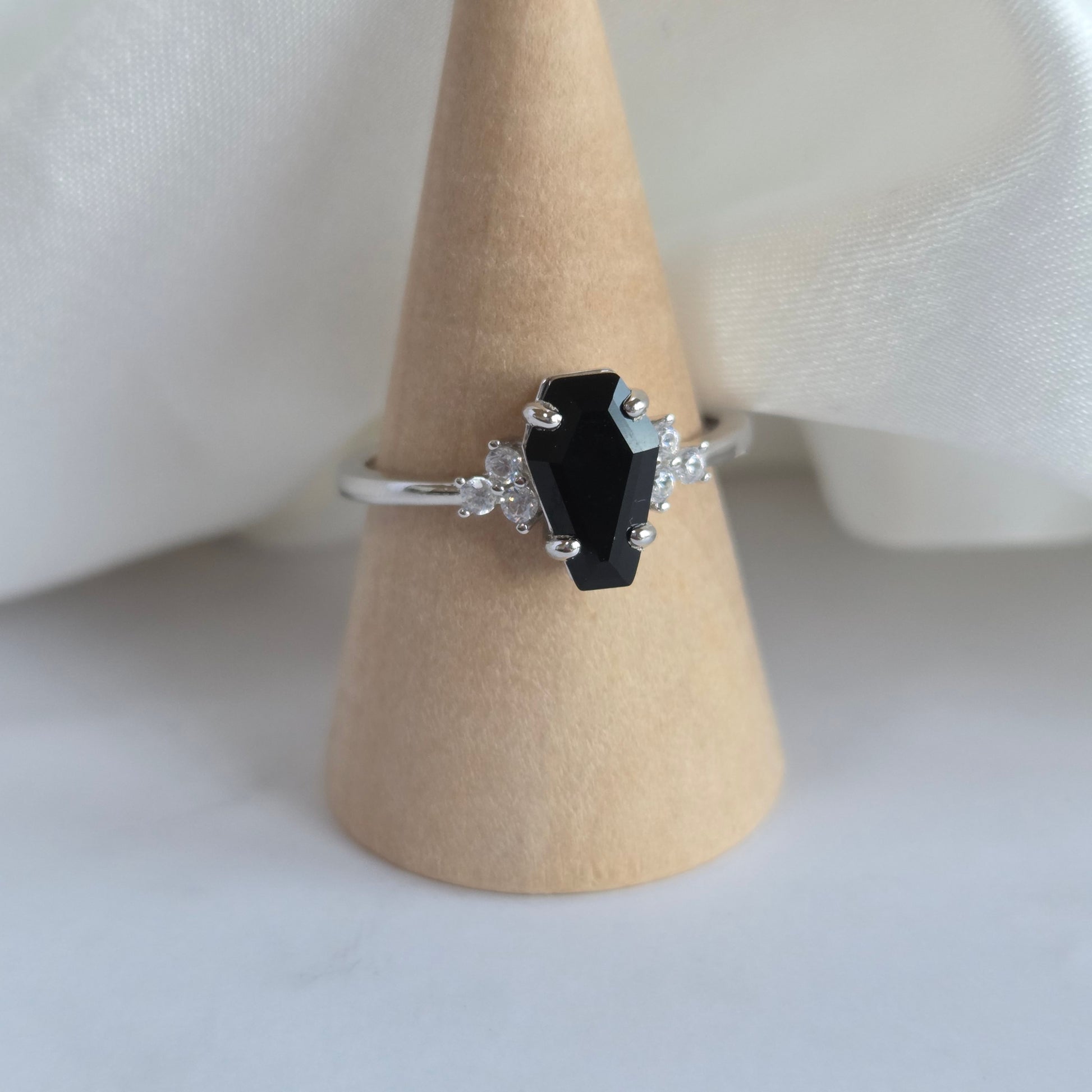 Silver ring with black onyx coffin shaped stone
