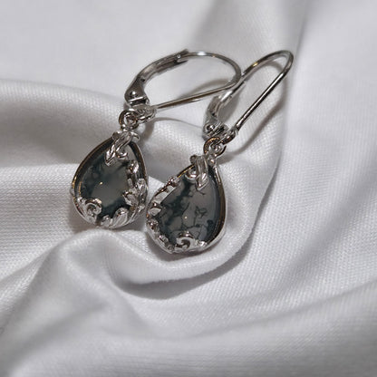 Silver teardrop earrings on a white fabric background moss agate earrings
