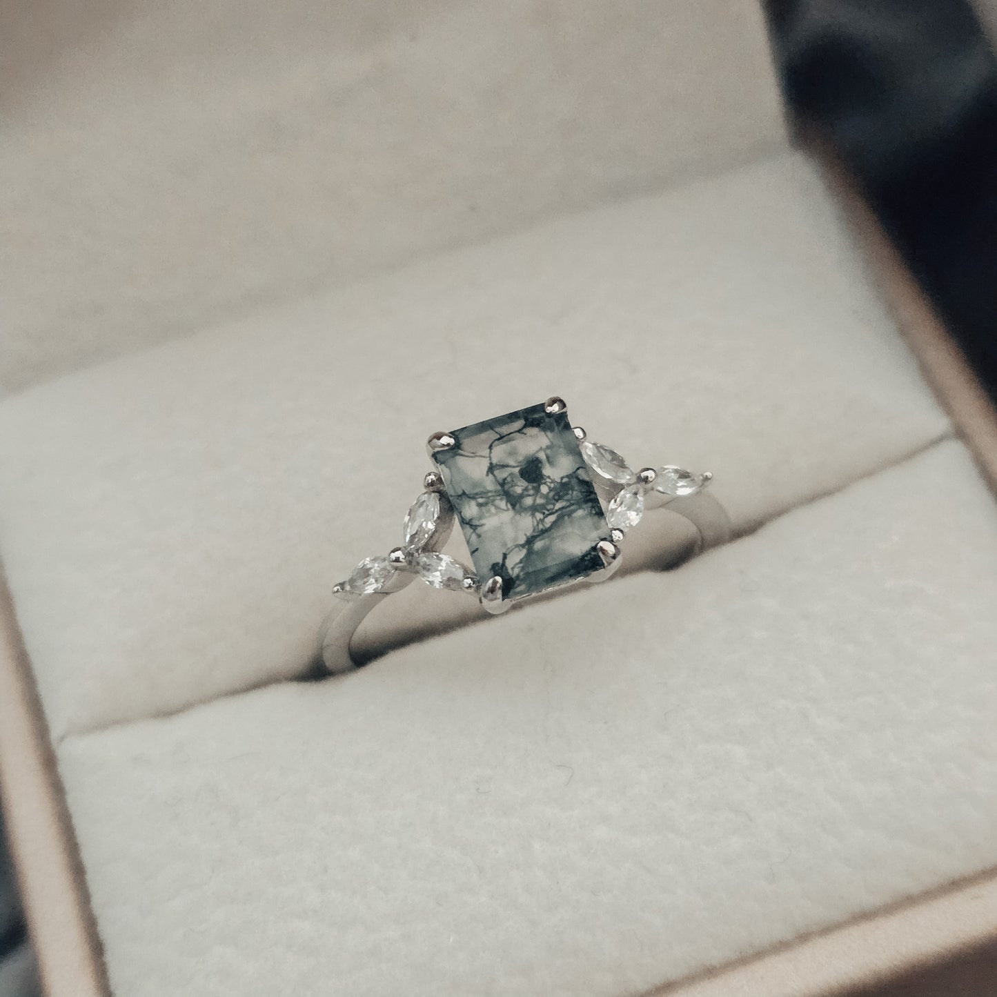 silver moss agate ring  ring with a greenish-blue stone in a jewelry box