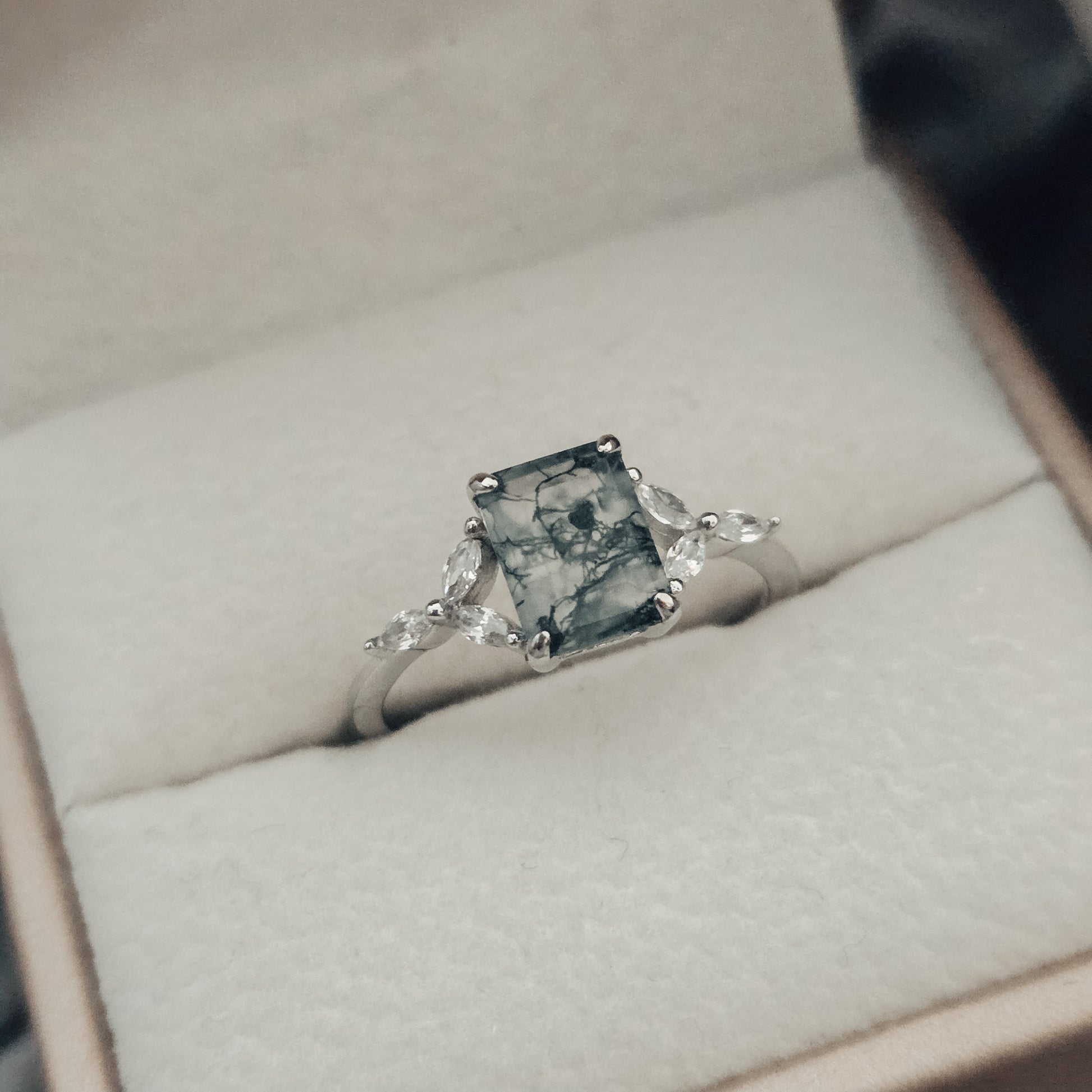 silver moss agate ring  ring with a greenish-blue stone in a jewelry box